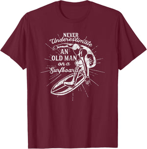 Never Underestimate An Old Man on a Surfboard-Funny T-Shirt - T-Shirt | Maroon