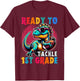 First Day Back to School 1st Grade Boys Football Dinosaur T-Shirt - T-Shirt | Maroon
