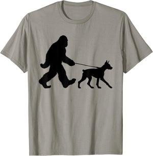 Bigfoot Walking a Dog Funny Doberman Pinscher Lovers Dog Dad T-Shirt - T-Shirt | Sand